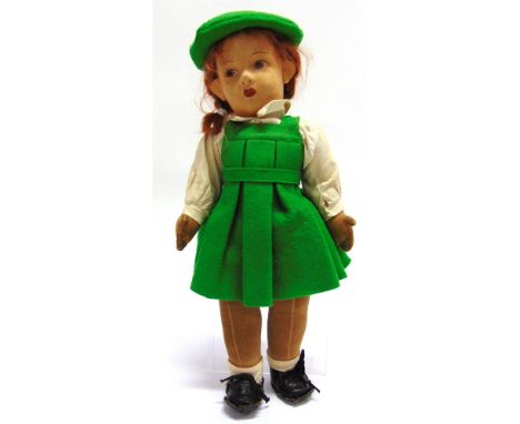 A CHAD VALLEY CLOTH GIRL DOLL with a plaited auburn wig and painted facial features, labelled to left foot, wearing a green d