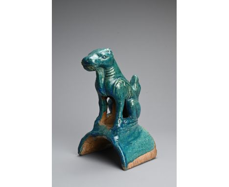 A CHINESE TURQUOISE GLAZED POTTERY ROOF TILE, MING DYNASTY. In the form of a seated dog. 22cm tall.     Provenance: Property 