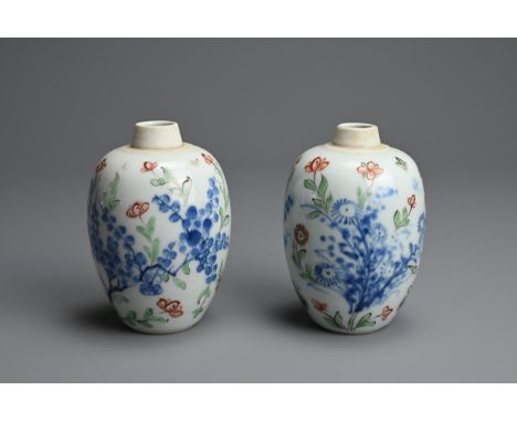 A PAIR OF CHINESE WUCAI PORCELAIN OVIFORM JARS, EARLY 18TH CENTURY. Decorated with flowering branches, each with leaf mark to