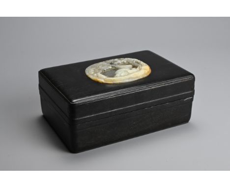 A CHINESE HARDWOOD BOX AND COVER WITH JADE INSERT, 20TH CENTURY. The pale celadon and russet jade plaque of oval form carved 