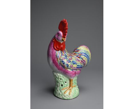 A CHINESE POLYCHROME DECORATED PORCELAIN MODEL OF A ROOSTER, 18TH CENTURY. Standing on a pierced base with its head turned to