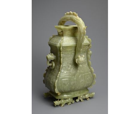 A CHINESE ARCHAIC STYLE CARVED JADE VESSEL, 20TH CENTURY. Modelled on the early wine vessels, You, from the Western Zhou and 