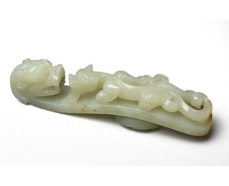 A LARGE CHINESE PALE CELADON JADE BELT HOOK, QING DYNASTY, 18/19TH CENTURY. Carved in openwork on top with a bearded chilong 