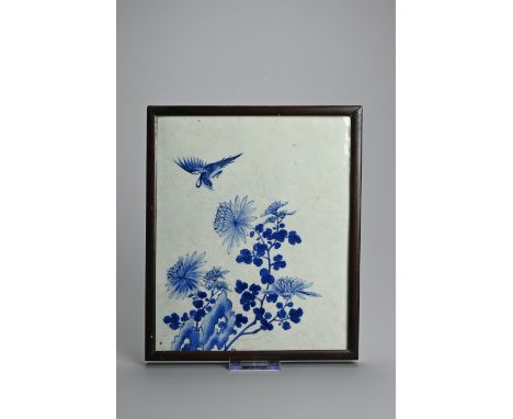 A CHINESE FRAMED BLUE AND WHITE PORCELAIN TILE, 19/20TH CENTURY. Of rectangular form decorated with bird and flowering chrysa