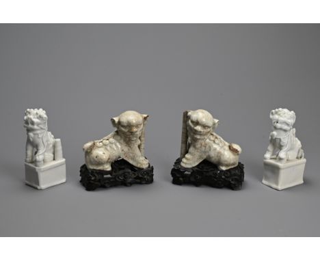 TWO PAIRS OF CHINESE PORCELAIN JOSS STICK HOLDERS, QING DYNASTY. In the form of lion dogs, seated with their heads turned cov