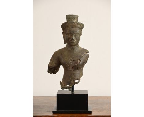 A CAMBODIAN BRONZE TORSO OF A DEITY, PROBABLY ANGKOR PERIOD 9TH - 14TH CENTURY. The male deity wearing a headdress mounted on