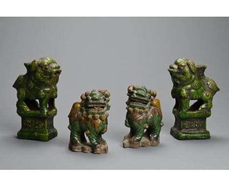 TWO PAIRS OF CHINESE GREEN AND SANCAI GLAZED POTTERY MODELS OF LIONS, MING / QING DYNASTY. In the form of joss stick holders.