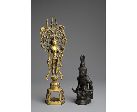 A CHINESE GILT BRONZE FIGURE OF BODHISATTVA WITH A BURMESE FIGURE. The bodhisattva standing in the Tang style standing on a l