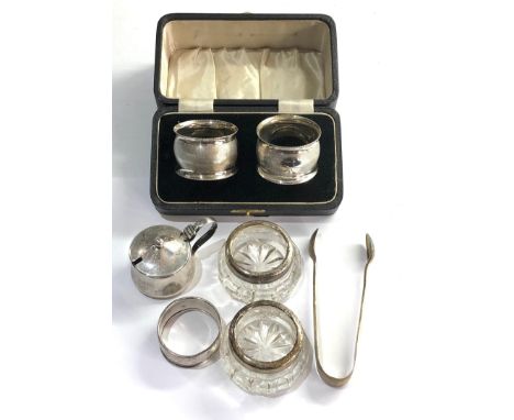 Selection of silver item includes salts sugar tongues napkin rings etc 