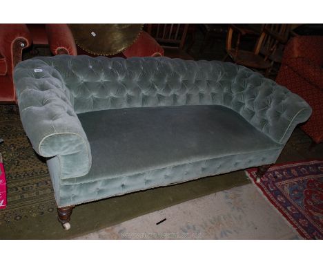 An Edwardian buttonback upholstered Chesterfield Sofa, in olive green draylon fabric with brocade detail, on turned legs with