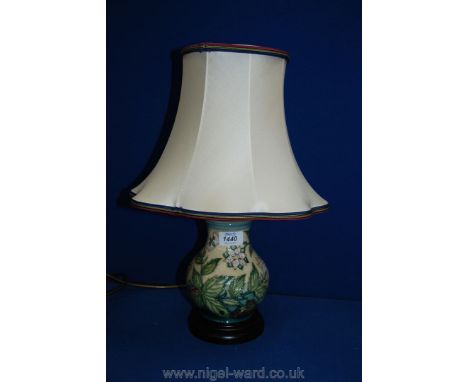 A Moorcroft 'Fruit Garden' design Table Lamp showing butterflies, bumble bees and foliage together with a hand woven silk sha