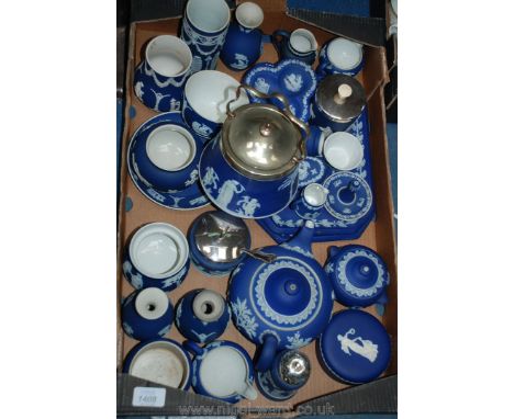 A box of blue Wedgwood jasper ware including bud vases, sugar sifter, teapot, cup, biscuit barrel, etc