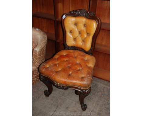 A good Victorian Rosewood framed Hall Chair with thick, tan leather, button upholstery, standing on scroll end legs.