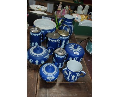 A quantity of blue Wedgwood jasper ware including a large jug, cheese dome cover, tyg, teapot, biscuit barrel,etc