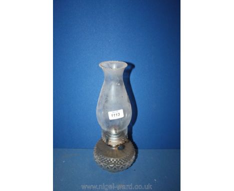 A circular glass Paraffin Lamp with decorative geometric pattern base and chimney with serrated top