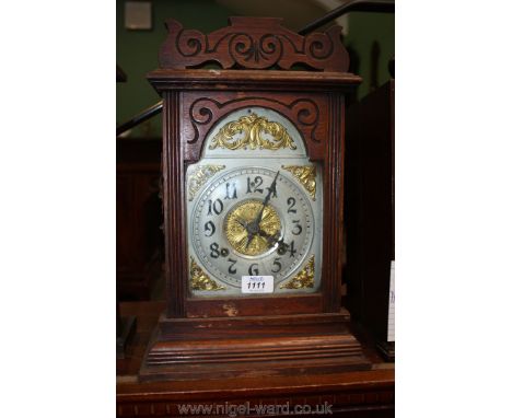 An Ansonia Clock Co; New York oak cased Mantle Clock: architectural case with alloy and gilt Arabic numeral face.  10 7/8" wi