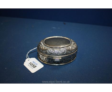 An unusual 20th c. oval white metal trinket Box with relief design to top and sides, 4" long