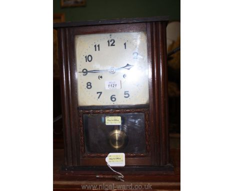 A circa 1900 oak American style Mantle Clock: single door with glazed pane with applied lower moulding, printed white face wi