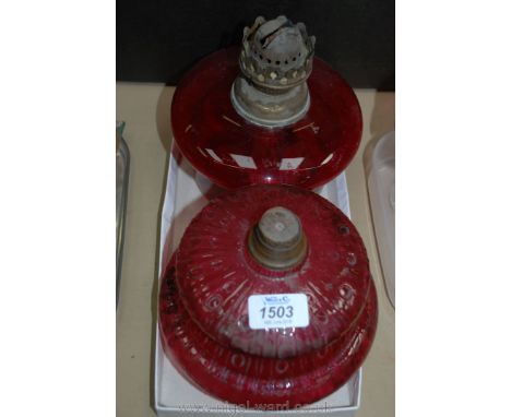 A Ruby glass Oil Lamp reservoir and a Cranberry glass reservoir