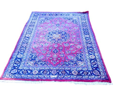 A Persian Meshed carpet, with a floral design surrounding a central blue pole medallion within multiple borders, 295cm x 200c
