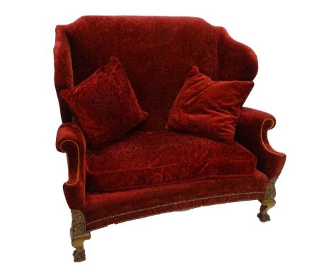 A mahogany wingback sofa in 18thC style, upholstered in red textured floral velvet, with gold piping on short cabriole legs, 