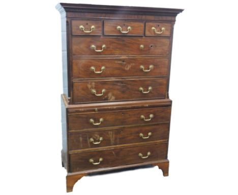 A George III mahogany chest on chest, the top with a moulded cornice above three short and three long drawers with brass drop