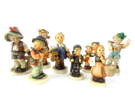 A collection of Hummel figures, to include a boy playing a violin, a boy with shoes etc.