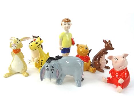 A collection of John Beswick for Royal Doulton Winnie the Pooh ceramic figurines, boxed.