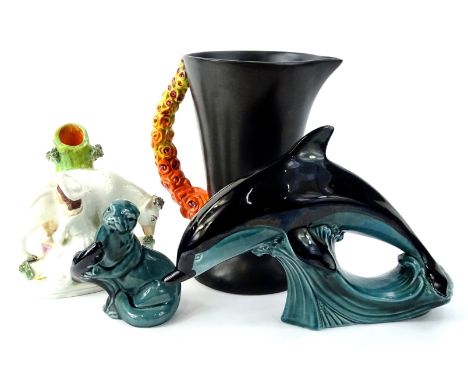 A collection of ceramics, to include a Staffordshire spill vase, modelled in the form of a lady milking a cow, a Poole potter