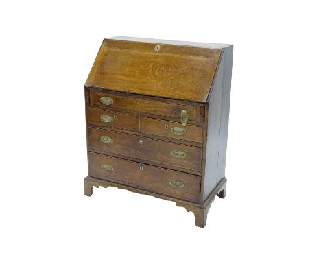 A 19thC oak and mahogany cross-banded bureau, the fall enclosing a fitted interior above four graduated drawers with brass ha