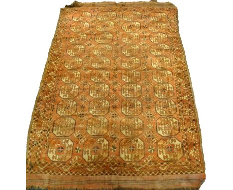 A Bokhara carpet, with a design of four rows of medallions on a red ground, 275cm x 180cm.