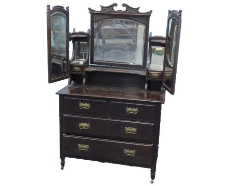 A late Victorian early 20thC Art Nouveau style mahogany dressing table, the raised back with a central mirror, flanked by two