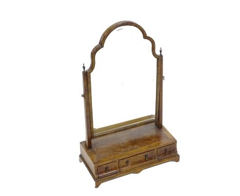 A walnut dressing table mirror in 18thC style, the shaped arch plate with a bevel edge on tapering supports with brass turned