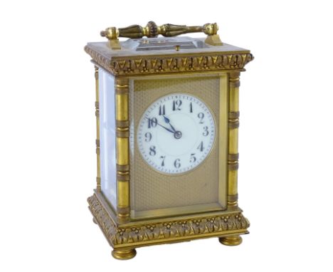 A French gilt brass carriage clock, with column framing, white enamel dial with Arabic numerals, eight day movement striking 