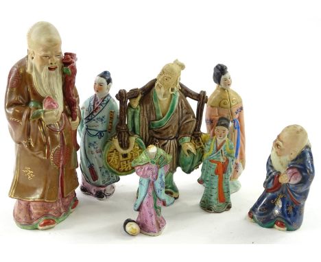 A collection of mainly souvenir oriental ceramic figures, to include immortals, figure carrying water etc.