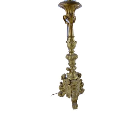 A 19thC carved gilt wood baroque table lamp on three feet.