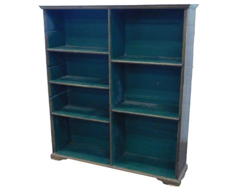 An oak open bookcase, with a moulded cornice, above an arrangement of adjustable and fixed shelves, on short bracket feet, 10