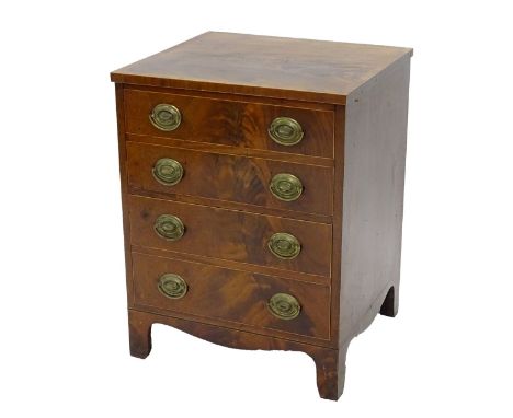 An early 19thC mahogany commode, with a cross banded top above a false drawer and a pull out drawer with fitted interior on b