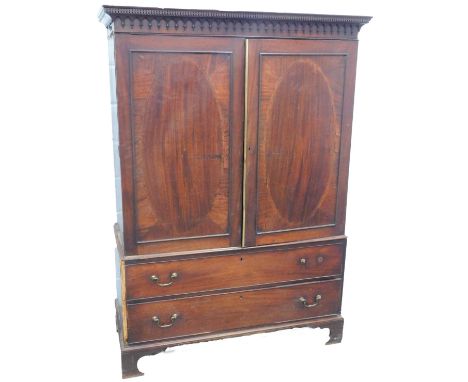 A 19thC mahogany linen press, the top with a dentil cornice above two flat panelled doors enclosing an adapted interior with 