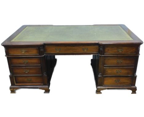 A mahogany partner's desk, in 19thC style, the inverted breakfront top with a green leather inset above an arrangement of six