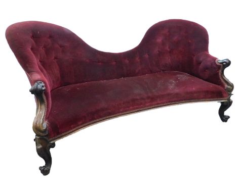 A Victorian rosewood sofa, with an hour glass shaped button back and seat, on scroll calf supports and legs, 152cm W.