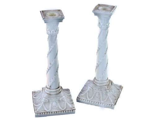 A pair of Royal Worcester neo classical blanc de chine candlesticks, Model 1050.