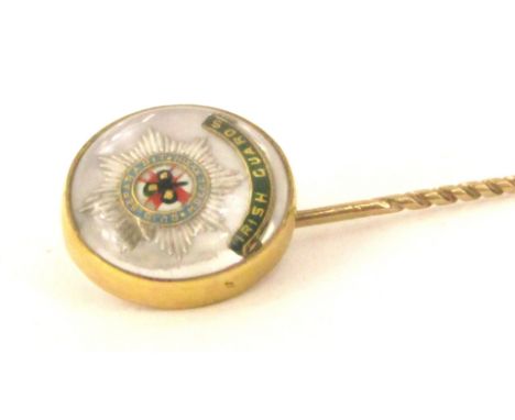An Irish Guards 9ct gold stick pin, the circular pin head with Irish Guards green enamel banner, and motif, 4.6g all in.