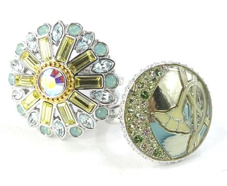 Two Swarovski crystal set dress rings, silver plated, one in the form of a floral cluster, with crystal set and enamel decora