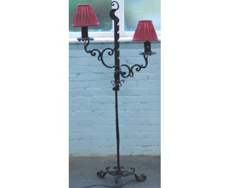 A wrought iron two branch standard lamp, decorated with scroll work, leaves etc., ebonised, 154cm H.