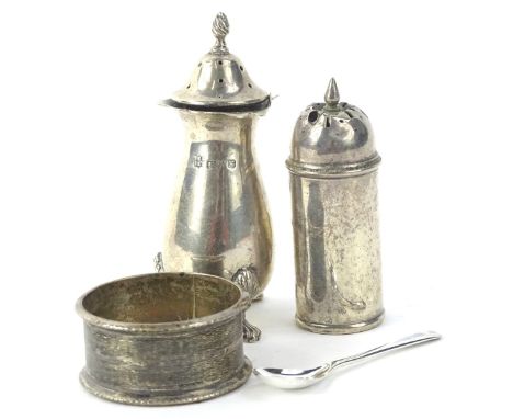 A collection of small silver, to include two pepper pots, enamel napkin ring, and a mustard spoon. 