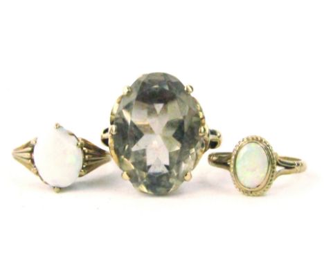 Three 9ct gold dress rings, to include a large smoky quartz set dress ring, and two opal set dress rings, 7.6g all in.