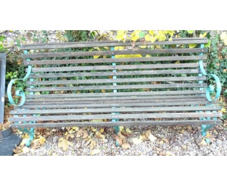 A slatted garden bench, with wrought iron supports, 179cm W.