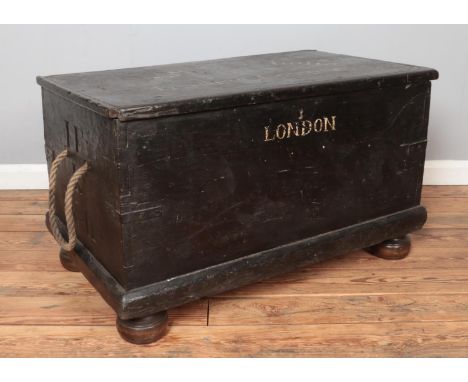 A painted wooden trunk stencilled for British East India Trading Company. Height 55cm, Width 95cm, Depth 55cm.  Signs of wood