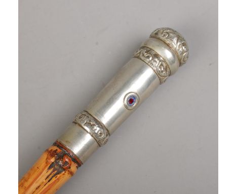An antique bamboo sword stick. With white metal pommel and collar. The pommel set with two small ruby coloured stones. Length